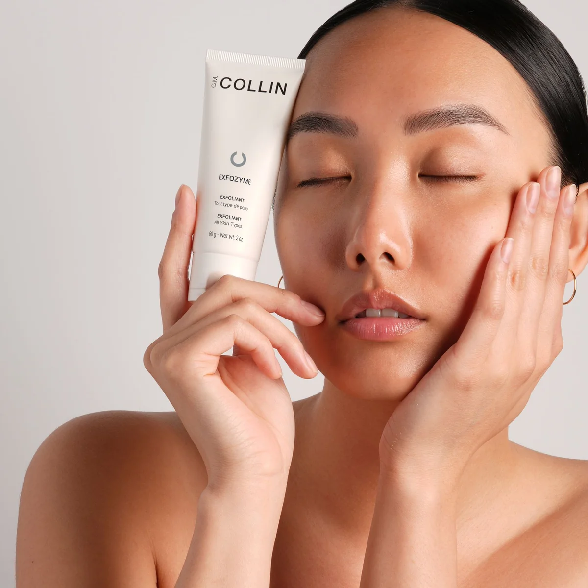 Exfozyme Exfoliant G.M. Collin - modèle tenant le tube exfoliant geste soin visage - Spa Santé Le Nénuphar