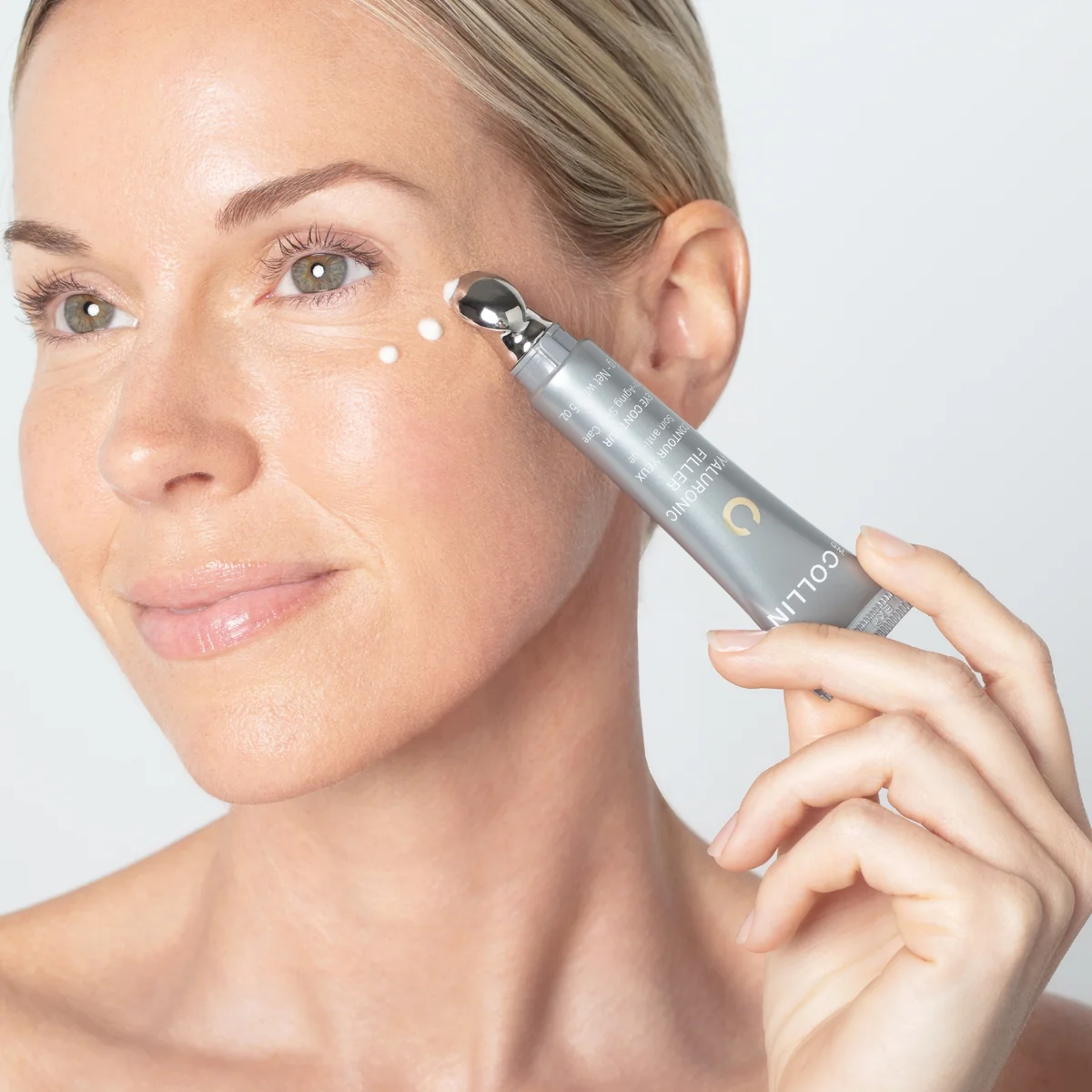 Hyaluronic Filler Contour des yeux G.M. Collin - modèle appliquant l’applicateur bille argenté sous l’œil - Spa Santé Le Nénuphar